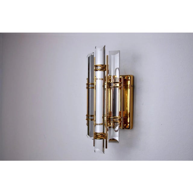 Very beautiful and small wall lamp from Venini dating from the 70s.Cut glass and golden metal structure. Unique object...