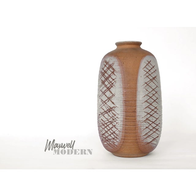 Gorgeous vintage vase from 1965 by California studio potter Victor "Vic" Bracke with incised abstract design on all four...