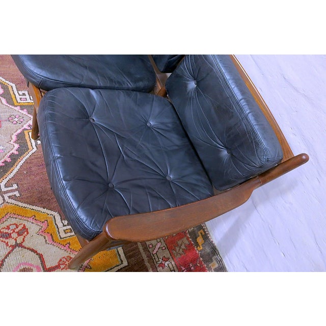 Rare 3-seater teak and leather sofa, model 'Cadett', the back cushions held by leather straps with brass buckles, designed...