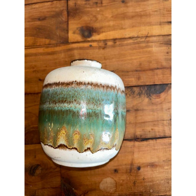Add a touch of unique artistry to your home with this charming vintage studio pottery vase. This piece stands out with its...