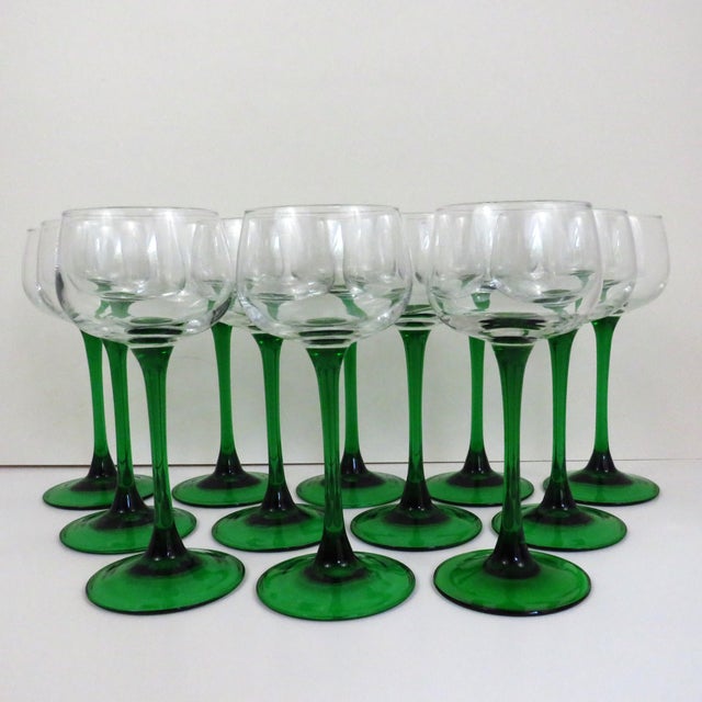 Vintage French white wine glasses from Luminarc, made from molds, with clear bowls and green stems and bases. Dated to...