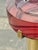 Striking Italian floor-standing ashtray from the 1970s, featuring a polished brass column and a substantial circular red...