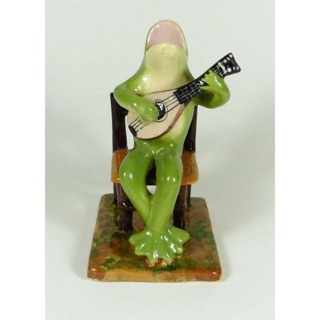 Rare unusual Majolica frog playing guitar sitting on a chair signed Jerome Massier, circa 1910.