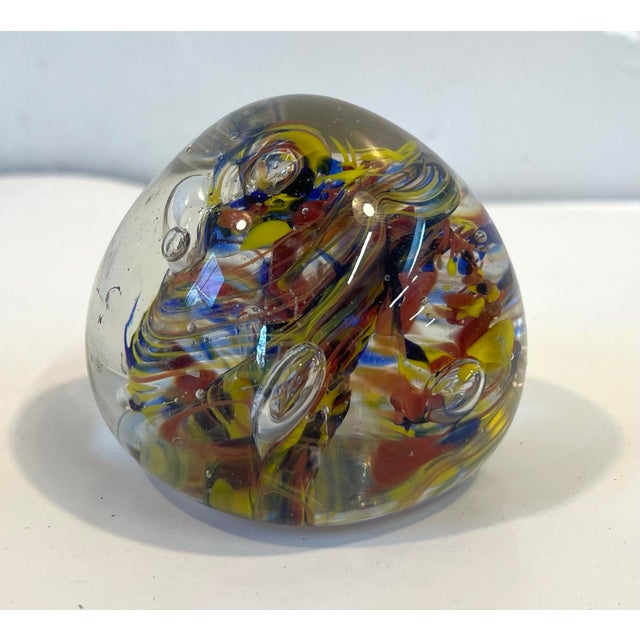 Nice vintage art glass paperweight in an egg shape with ground flat bottom. Swirl design