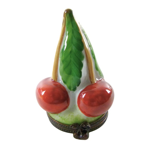 The Limoges Cherries box opens at the base to display the hand written Hallmark ( a "Peint main . Limoges B.R.C."). The...