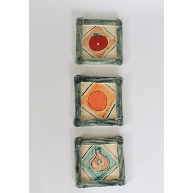 Set of three vintage studio art ceramic wall hangings by Rhonda Cearlock. Features Garlic, Tomato and an orange. Minor age...