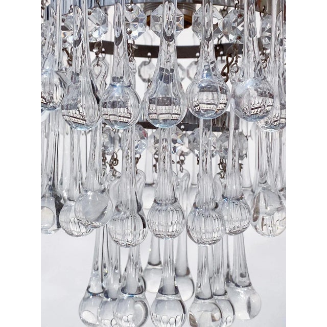 Italian layered chandelier with brass rim and 30% leaded hand blown crystal teardrops. It has 1 Edison base socket that...