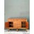 This vintage credenza is a low, rectilinear case piece wrapped in a framework of honey-toned rattan and bamboo, with the...