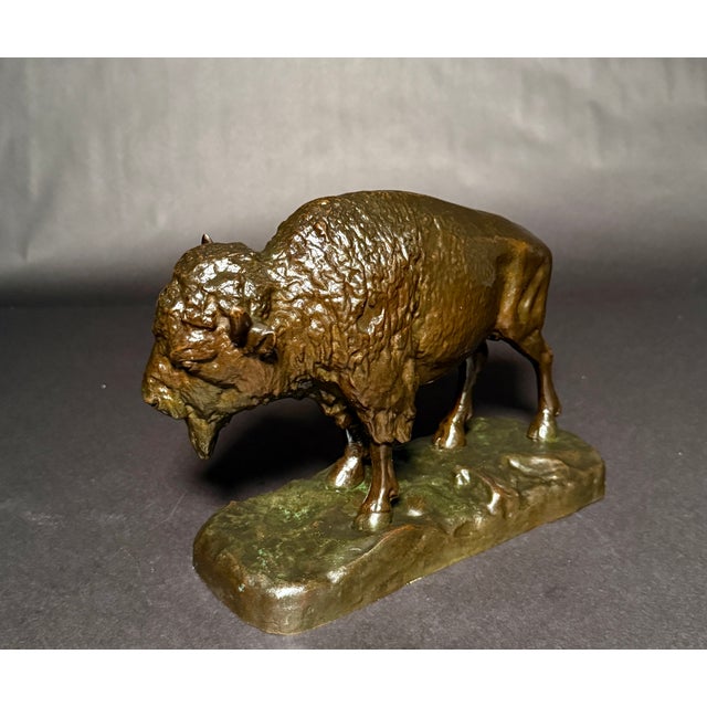 This finely crafted bronze sculpture depicts a powerful American bison in a naturalistic stance, capturing the animal’s...