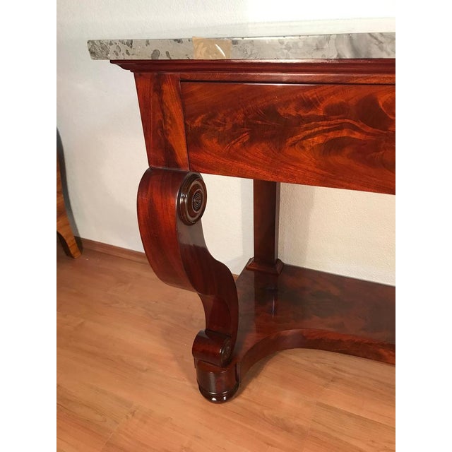 This elegant French Restoration console table, crafted between 1820 and 1830, reflects the refined transition toward the...