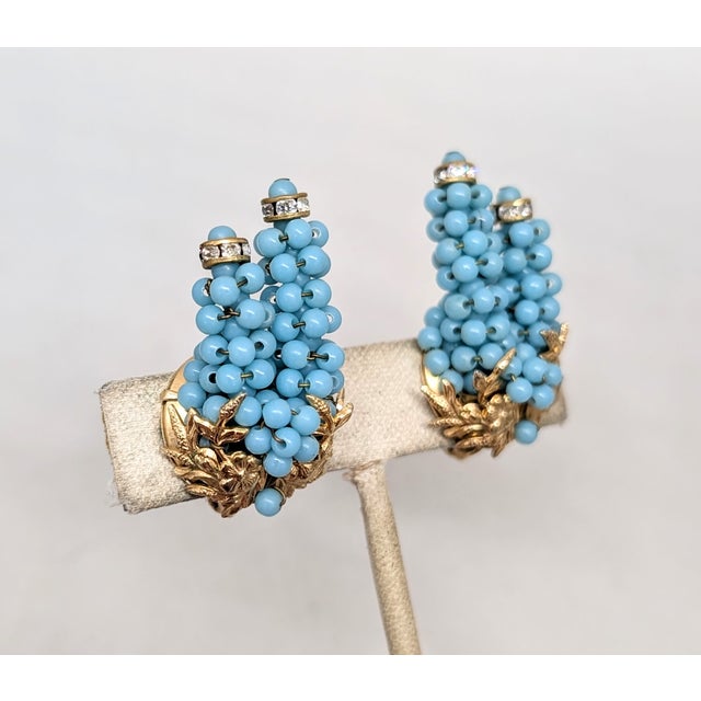 Rare 1950s goldtone hand wired two "stacks" of faux-turquoise beads with channel set round clear rhinestones around the...
