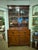 This is a beautiful English secretary bookcase with extended desk. The upper glass front doors are original to the piece....
