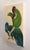 This artwork features a figure seated with their back to the viewer, draped in flowing green and blue brushstrokes that...