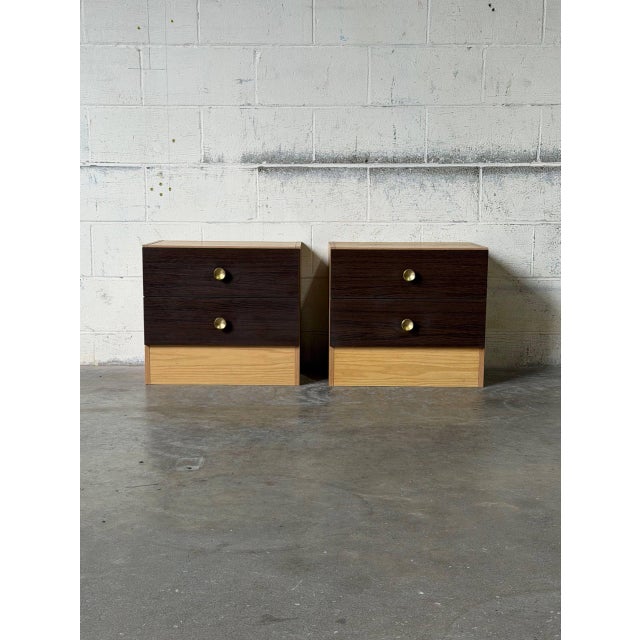 This matching pair of two-drawer nightstands features a striking two-tone design with clean lines. Their minimalist...