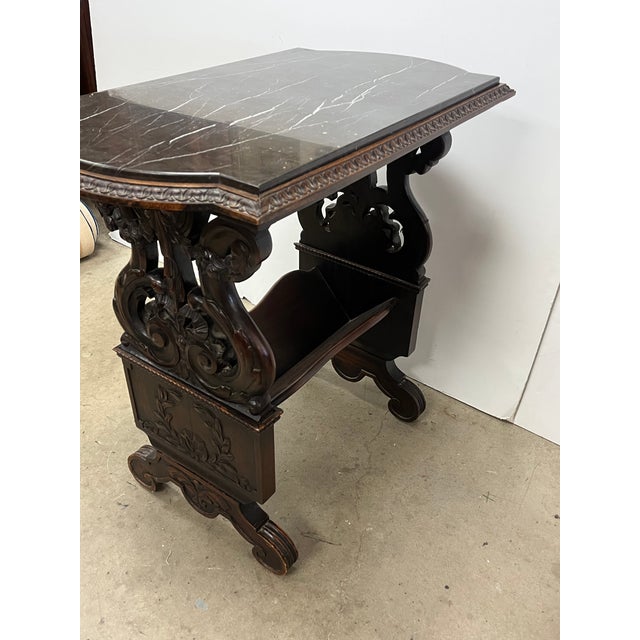 1920's Highly Carved Side Table w/Marble Top. Intricately carved antique Renaissance Revival side table with bookcase...