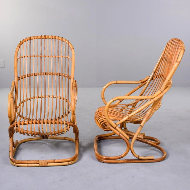 Found in Italy, this pair of rattan armchairs were designed by Tito Agnoli in 1959. Rectangular base with scoop-form seats...