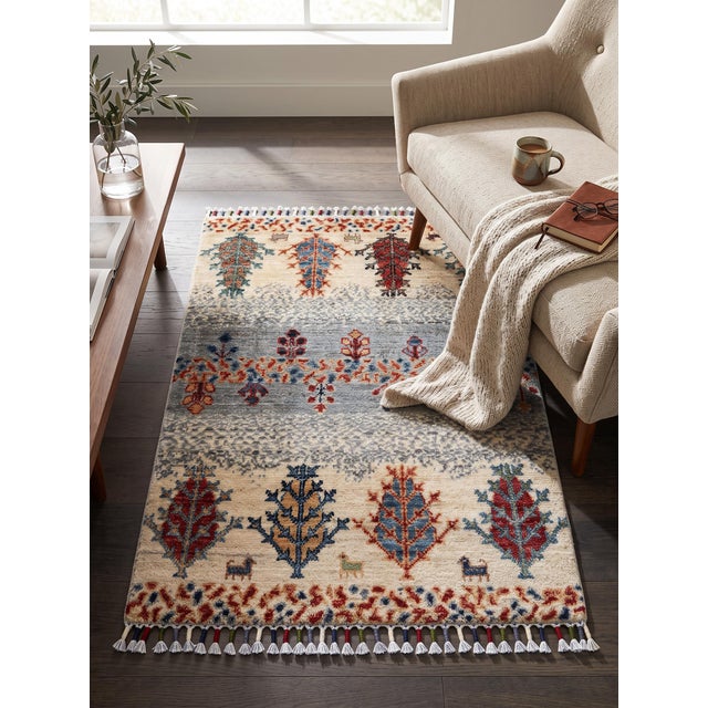 A small hand-knotted Gabbeh rug in the Persian Gabbeh tradition, worked in bands of soft ivory and slate blue and planted...