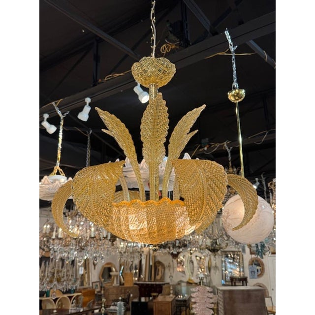 The Amber Colored Murano Glass Leaf Chandelier is a stunning of lighting fixtures that adds a touch of elegance and...