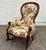 This is a stunning antique Victorian style walnut rocking chair featuring a tall balloon back, richly carved and molded...