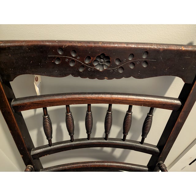 Antique Victorian Eastlake-style armchair featuring beautifully turned spindle detailing, carved floral crest rail, and...