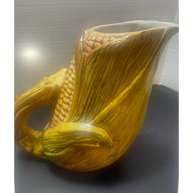 Vintage ceramic corn pitcher featuring a sculptural ear-of-corn design with raised kernels, layered green husk detailing,...