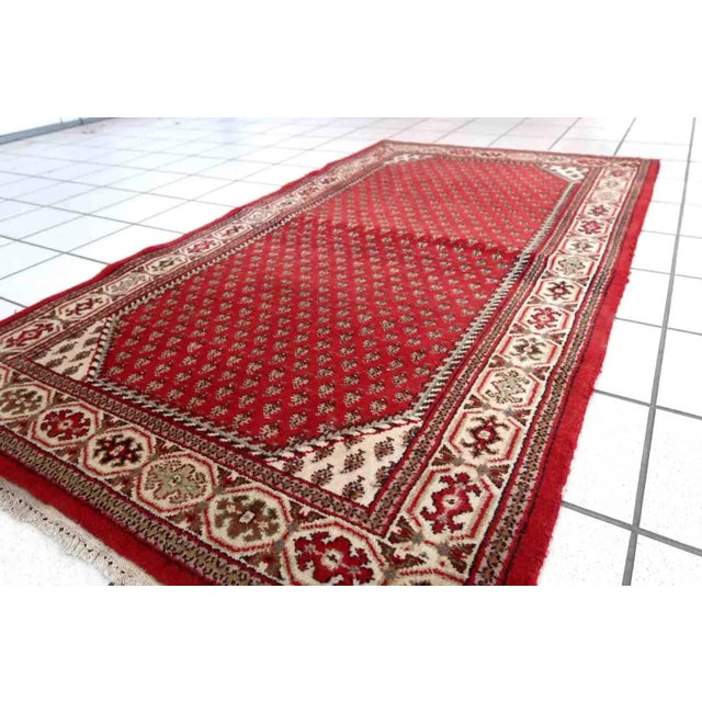 Handmade vintage Indian Seraband rug in red color and all-over design. The rug has been made in the end of 20th century....