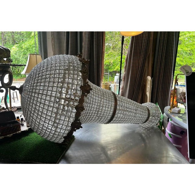 Up for consideration is a beautiful vintage oversized gold and crystal chandelier with detailed accents. This would look...