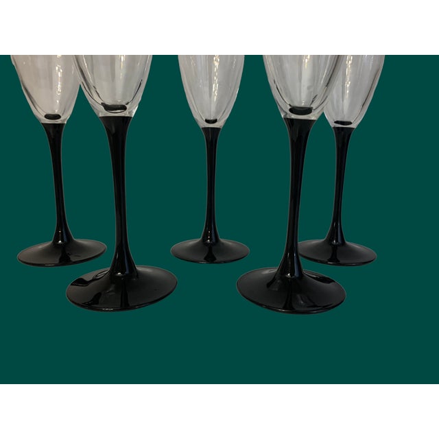 Luminarc France black stem crystal champagne flutes. A set of 5.