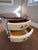 Elegant cream-colored cabinet with a beautiful brown top. Features two drawers with softly rounded corners, giving the...