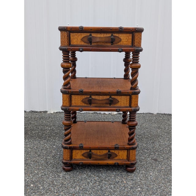 Elevate your living space with this exquisite vintage multi-tier wicker and rattan étagère stand by master furniture maker...