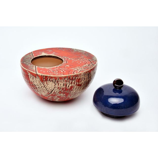This round vase-like multicolored ceramic urn is a unique piece crafted with care and passion. This beautiful memorial...