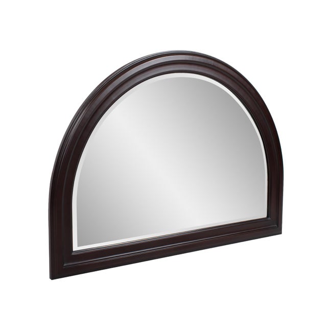 The George Mirror features a lacquer finish. The arched frame is made from wood and is accented with grooves for added...