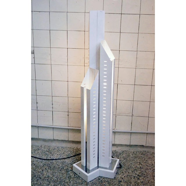 1970s skyscraper-shaped floor lamp in painted metal with chromed part produced by Tronconi in Italy. This piece is...