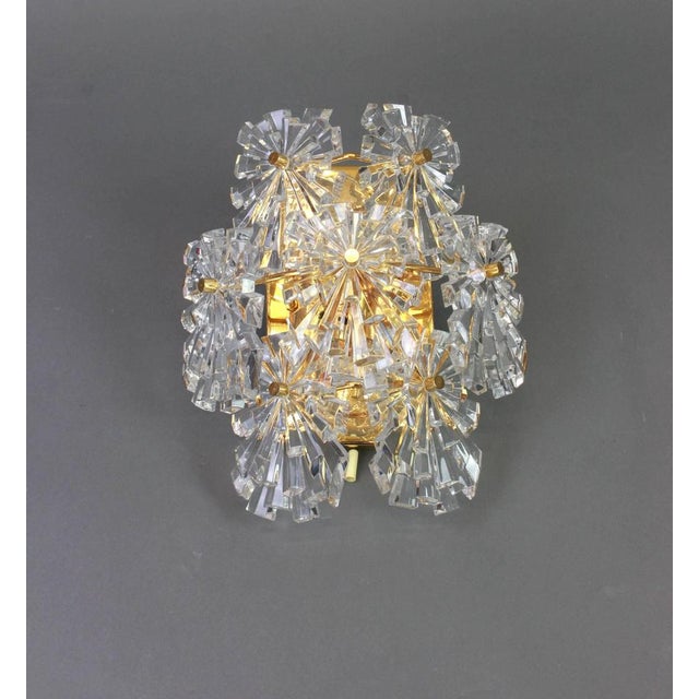 A stunning pair of golden sconces with crystal glasses, made by kinkeldey, germany, circa 1970-1979. It’s composed of...