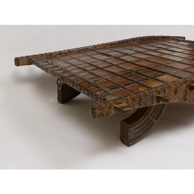 Beautiful hardwood strapped with decorative iron Formerly a camel cart - legs have been made from the original wheels...