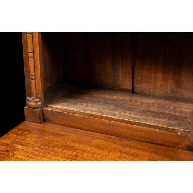 Antique walnut apothecary with glass cabinet doors. This extravagant piece features a multitude of uniform drawers,...