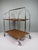 This dinett serving trolley by bremshey is a refined example of post-war european functional design. Its chromed tubular...