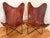 This pair of vintage butterfly chairs with worn leather seats are the perfect mix of modern and rustic. Warm mahogany-...