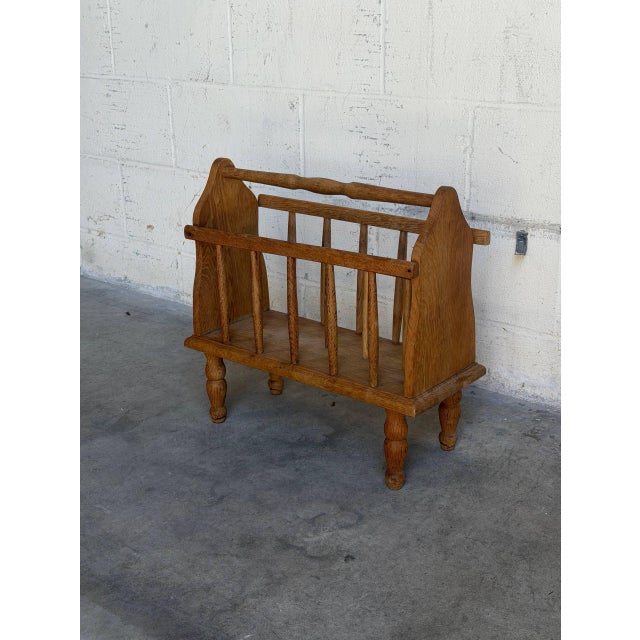 Vintage Danish magazine rack crafted from solid oak featuring traditional Scandinavian craftsmanship and charming turned...