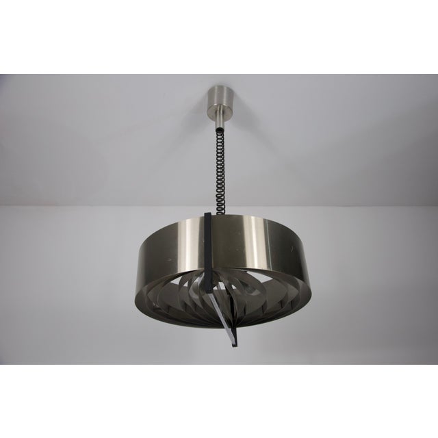 This vintage italian chrome retractable ceiling lamp is not only a beautiful statement piece but also a functional source...