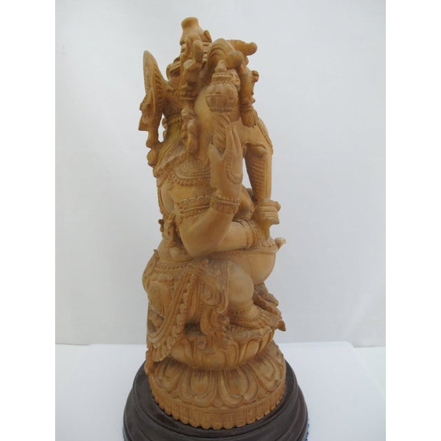 Seated Lord Ganesha Holding Fruit Carved Wood Hindu Deity God Statue on Pedestal For Sale - Image 4 of 13