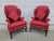 A beautiful pair of Baker Furniture burgundy upholstered wingback chairs from their Historic Charleston collection. Each...