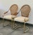 A pair of vintage 1970s cantilevered chrome and wicker armchairs made by over a century old company Bassett Mirror Co....
