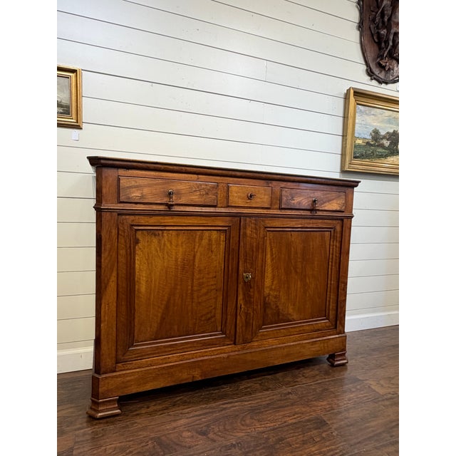 This is a beautiful 19th century French server featuring a three upper drawers above two doors that opens into storage....