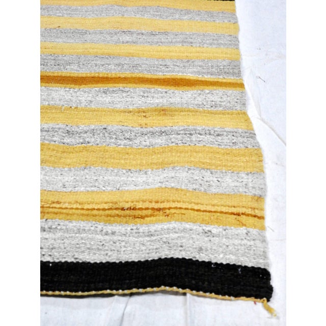 This is a nice, regional Navajo weaving in gold and natural heathered taupe stripes with dark brown borders at each end,...