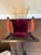 Regency style ebonized and gilt accented armchair with fuchsia and purple fabric.