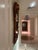 An exquisite carved wood mirror featuring a dramatic ribbon‑form surround, sculpted in deep folds that create movement,...