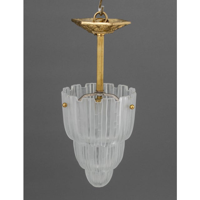 Sabino French Art Deco "Waterfall" Pendant Lamp, with gilt brass ceiling mount, the tiered frosted glass shade marked...