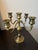 Elegant vintage brass candelabrum crafted in India, featuring five gracefully curved arms surrounding a turned central...