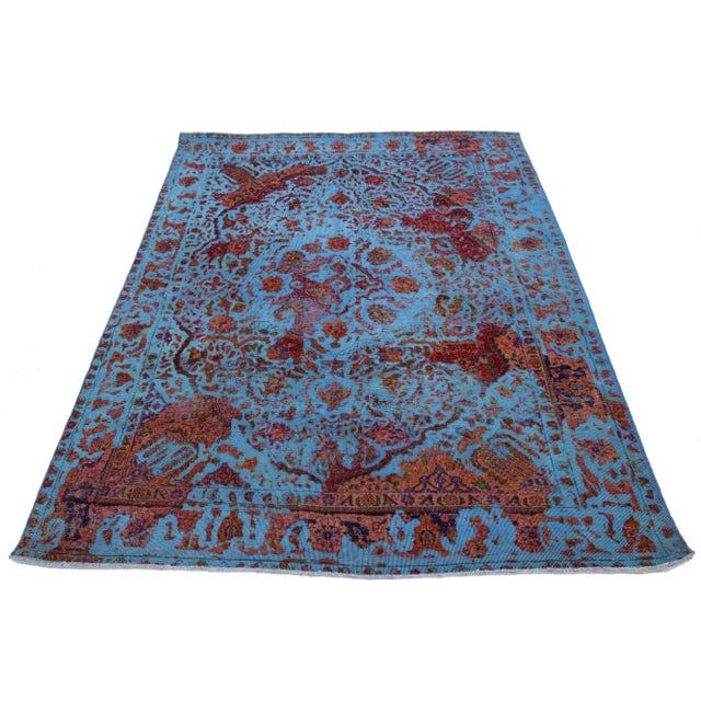 This exquisite vintage Persian wool rug boasts a captivating blue field adorned with charming rusted floral accents. This...
